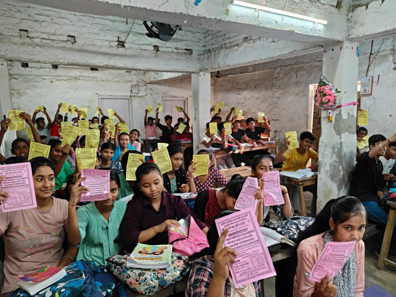 Students with scholarship information leaflets — Nirmali · 2025
