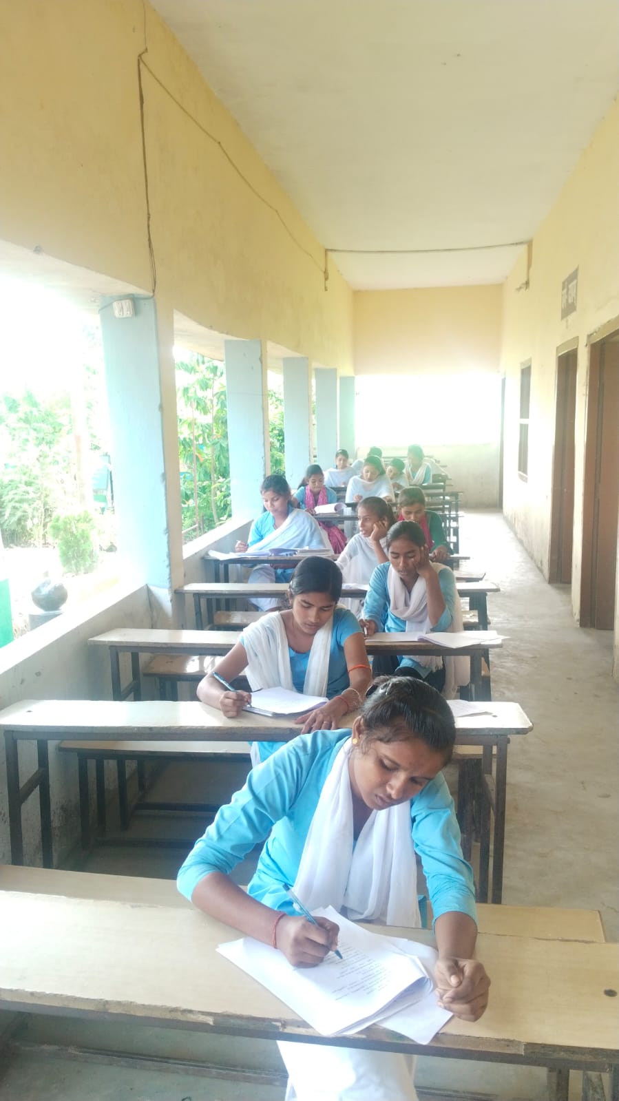 Students seated along the school corridor — Barhara, 2025