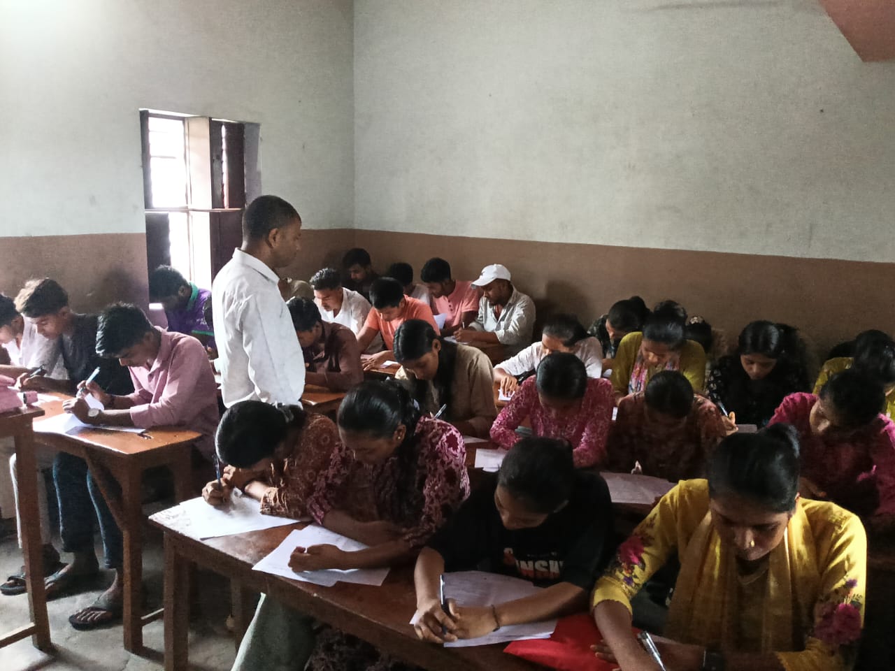Students taking the written examination — Nirmali